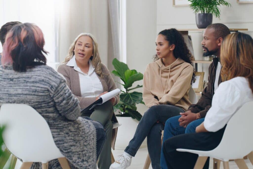 People sitting in a circle and discussing addiction in men vs. women