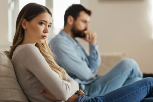 a couple sits angrily with each other asking does tough love work with addiction