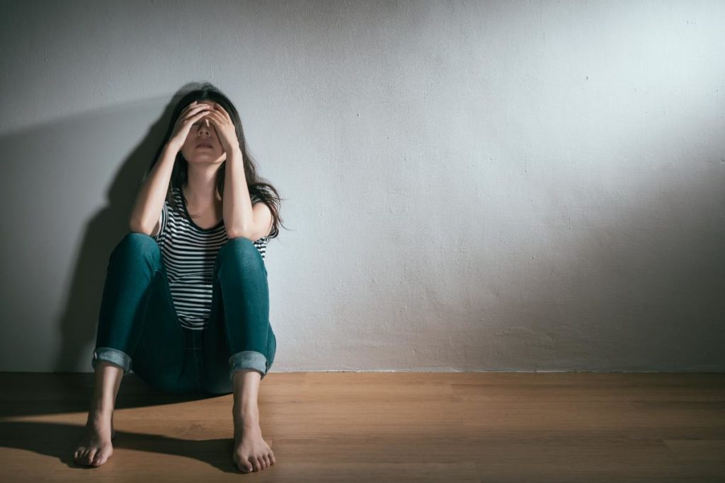 woman leaning against wall