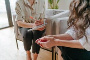 Hands of two people talking about the commonly abused prescription drugs