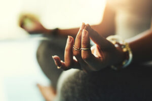 Hands of person meditating and thinking about the difference between holistic detox and medical detox