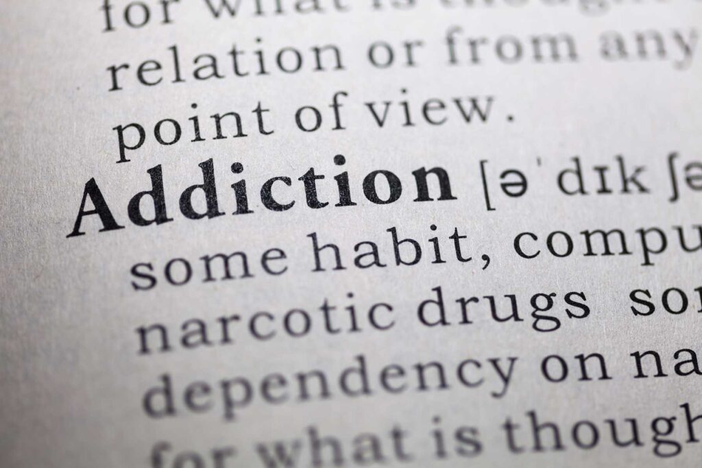 Definition of addiction in a dictionary, which doesn't list signs of addictive behavior