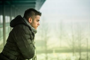 a person looks sadly over a cold landscape thinking of prescription stimulant abuse