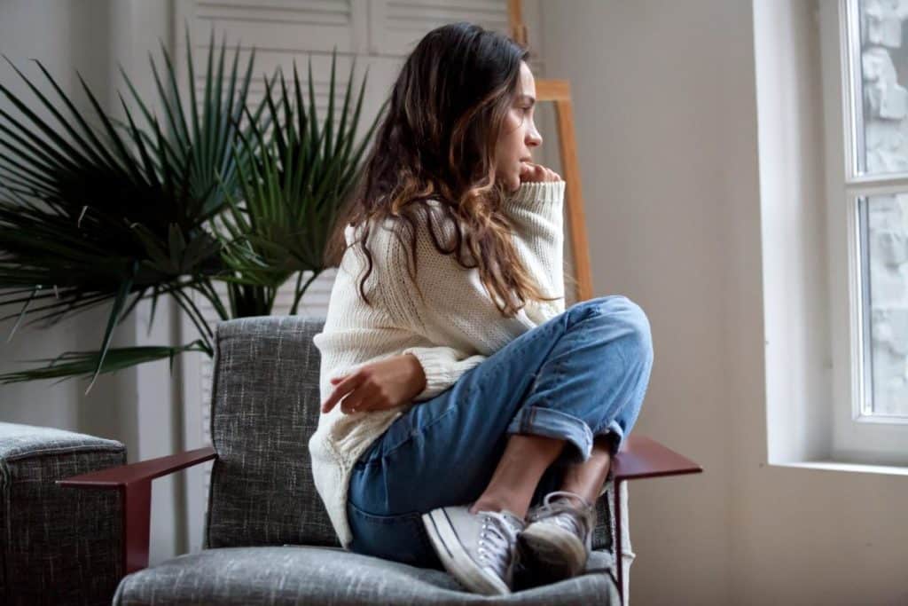 woman staring outside window