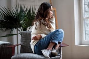 woman staring outside window