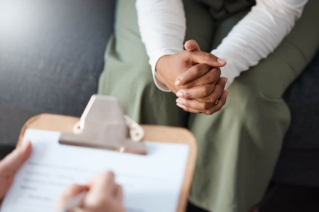 Hands of a person learning how heavy drinking affects their brain and life