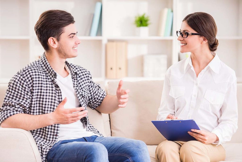 a person speaks with a therapist during one of many treatments for ptsd