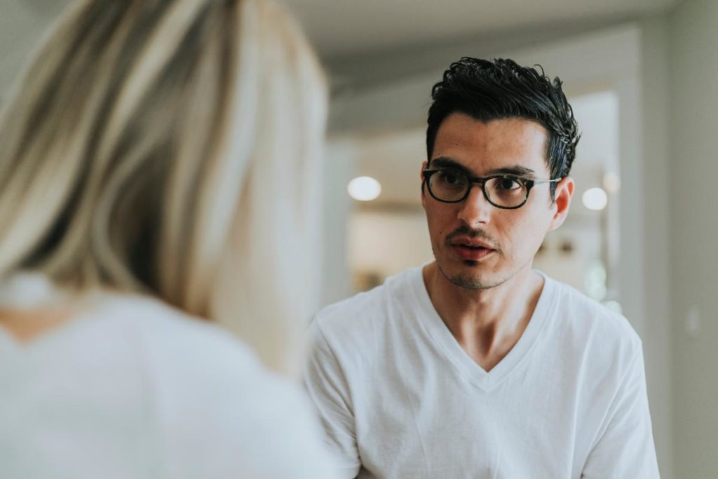 a person looks at someone in shock after asking what is gaslighting