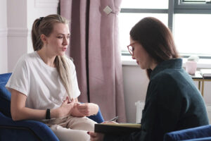 Two people talking at an anxiety treatment program