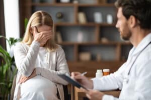 Person breaking down in front of someone else at a depression treatment program