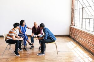 People sitting in a circle learning what co-occurring disorders are treated with