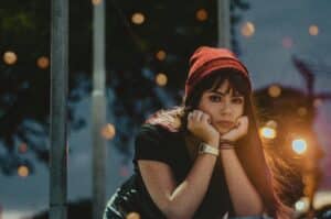 A young woman leaning forward dealing with boredom in sobriety