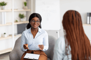 A woman asking a treatment professional how long alcohol rehab is