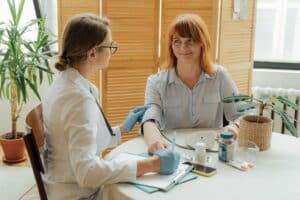 a woman beginning the medical detox process with a nurse in rehab