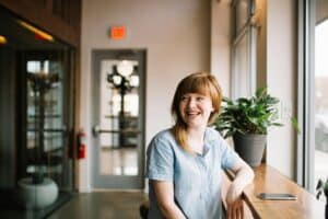 woman sitting at table smiling