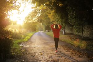 woman walking a path outside in the sun
