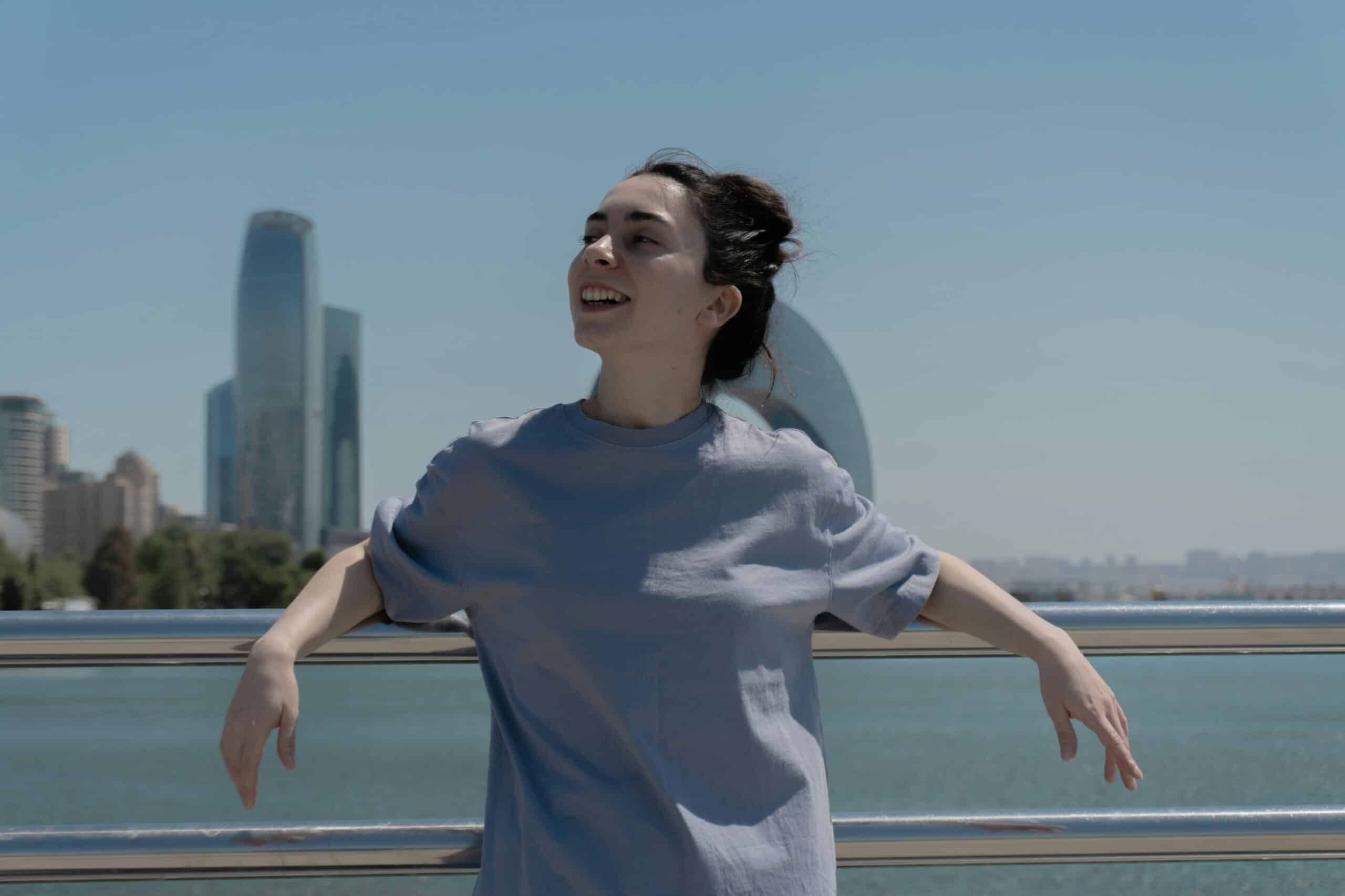 woman smiling standing with her back against the bridge